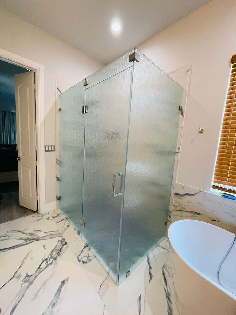 Rain pattern textured tempered glass shower enclosure with water droplet pattern in luxury bathroom